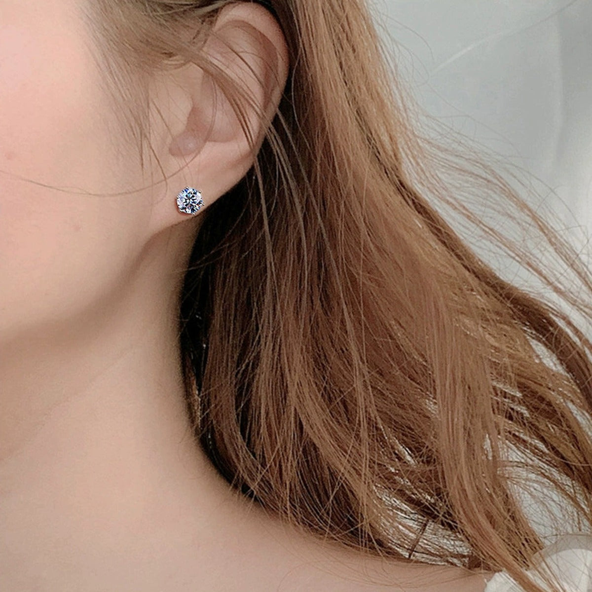 Magnetic Clip-On Round Moissanite Stud Earrings in Gold-Plated S925 sterling silver worn on ear by model showing scale, placement, and stud earrings styling