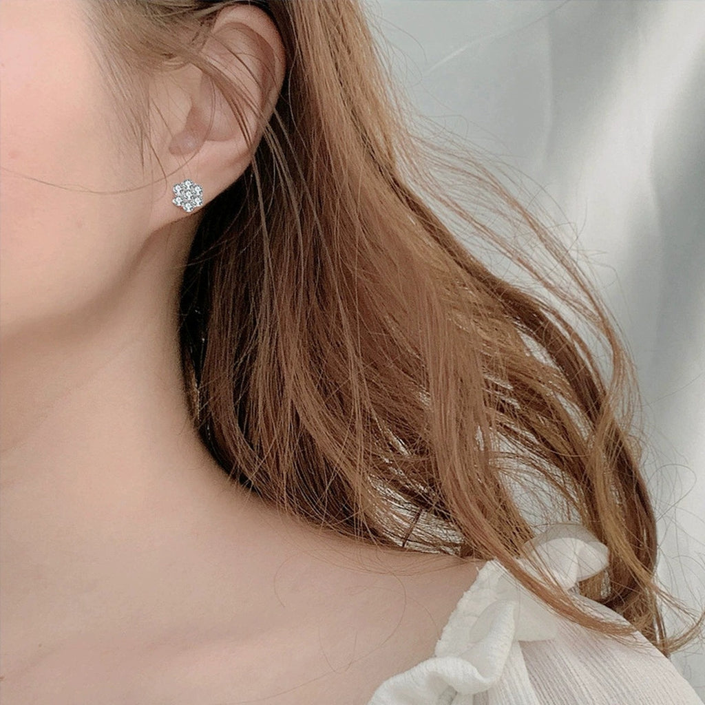 Floral Cluster Round Moissanite Stud Earrings in White Gold-Plated S925 sterling silver worn on ear by model showing scale, placement, and stud earrings styling