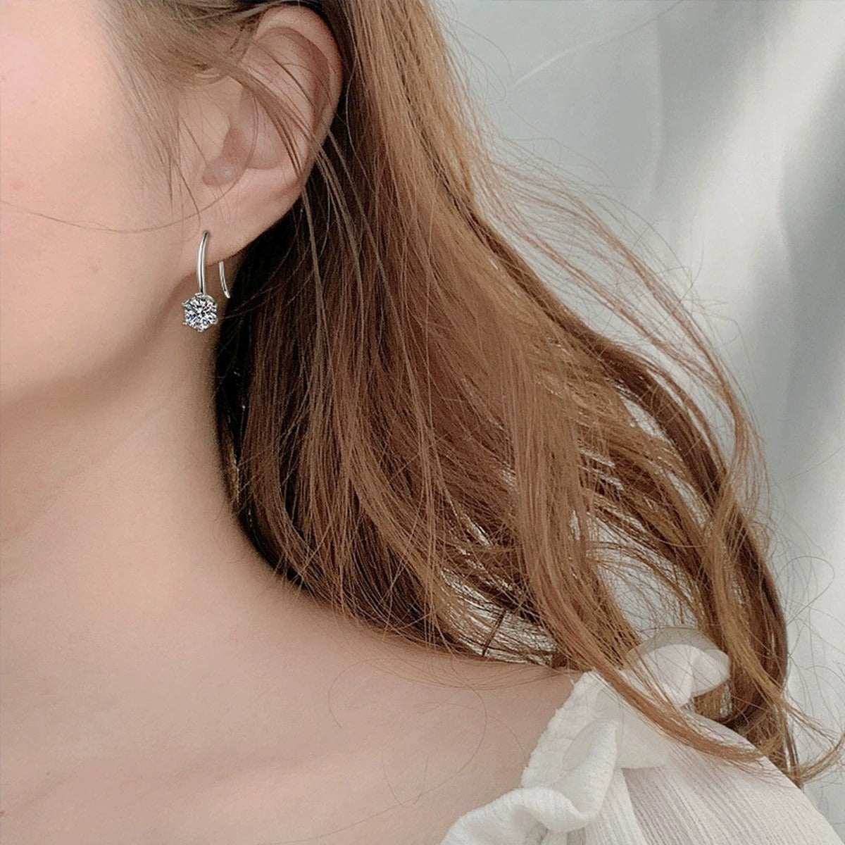 Round Moissanite Solitaire Hook Drop Earrings in White Gold-Plated S925 sterling silver worn on ear by model showing scale, placement, and hook drop earrings styling