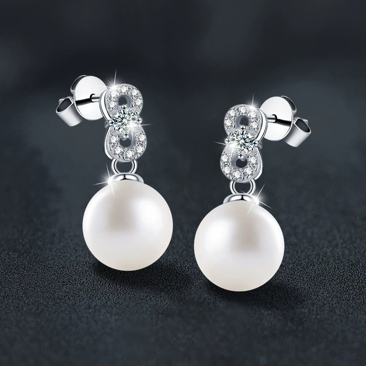 Infinity Round Moissanite and Pearl Stud Dangle Earrings with CZ in White Gold-Plated S925 sterling silver product scene view showing angled setting detail