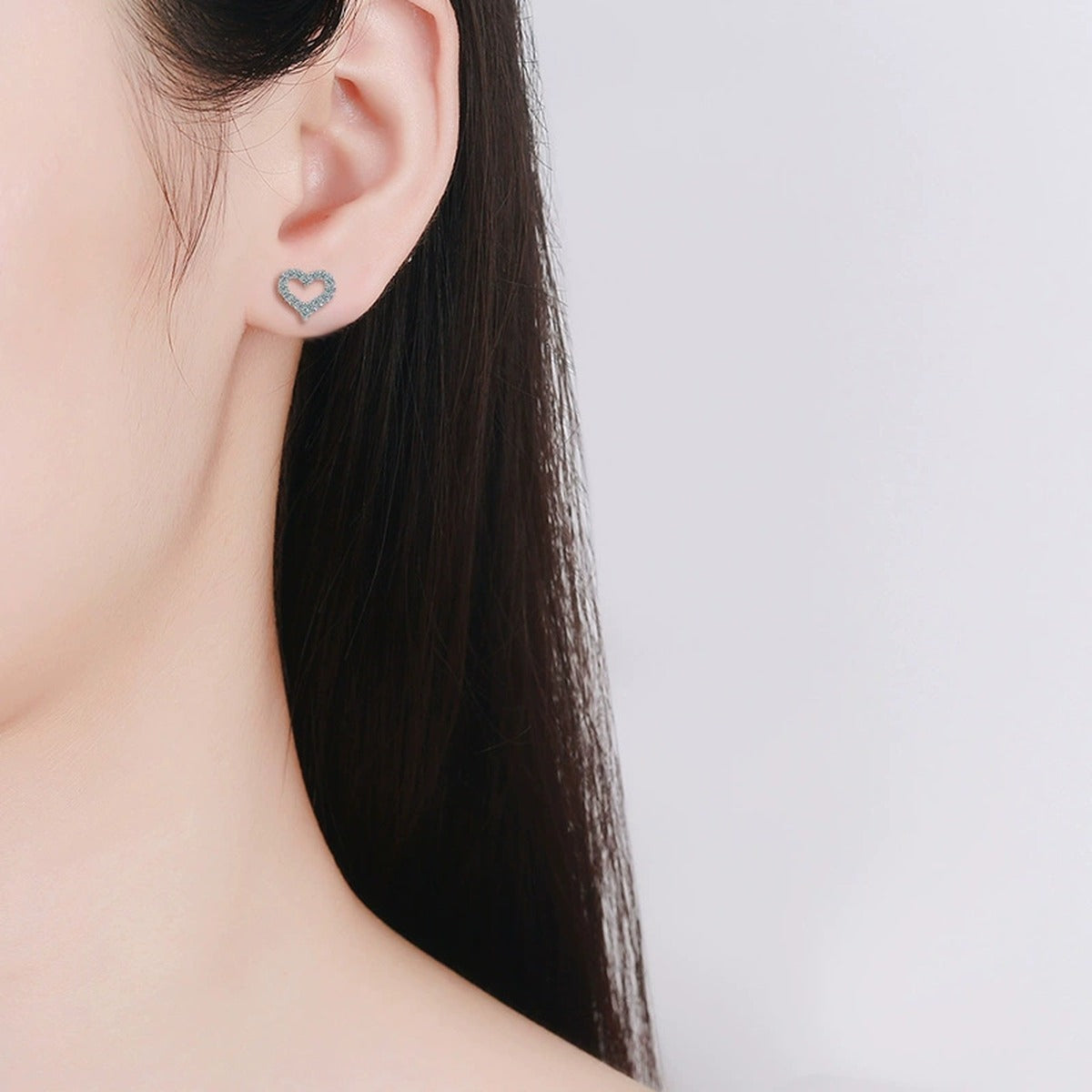 Open Heart Pave Moissanite Stud Earrings in White Gold-Plated S925 sterling silver worn on ear by model showing scale, placement, and stud earrings styling