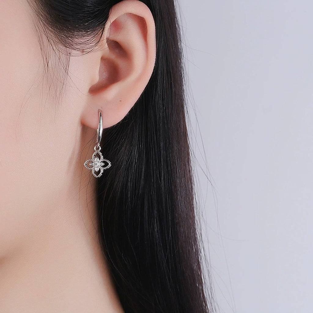 Four-Leaf Clover Round Moissanite Hook Dangle Earrings with CZ in White Gold-Plated S925 sterling silver worn on ear by model showing scale, placement, and hook dangle earrings styling