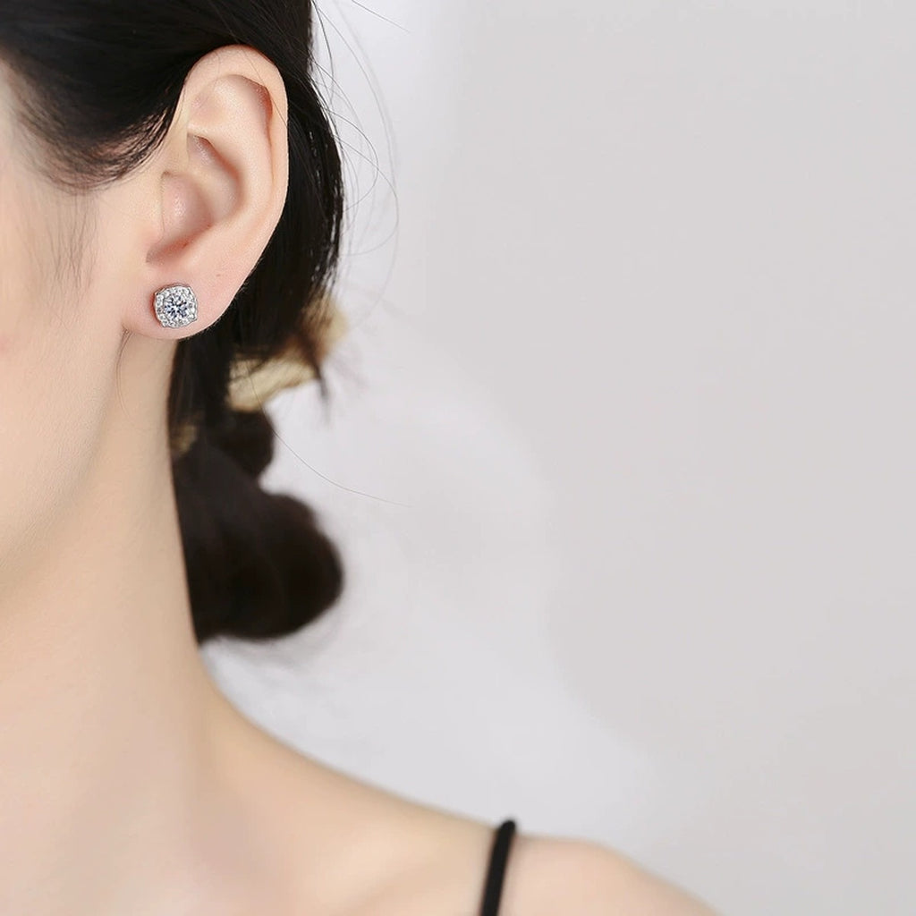 Cushion Halo Round Moissanite Stud Earrings with CZ in White Gold-Plated S925 sterling silver worn on ear by model showing scale, placement, and stud earrings styling