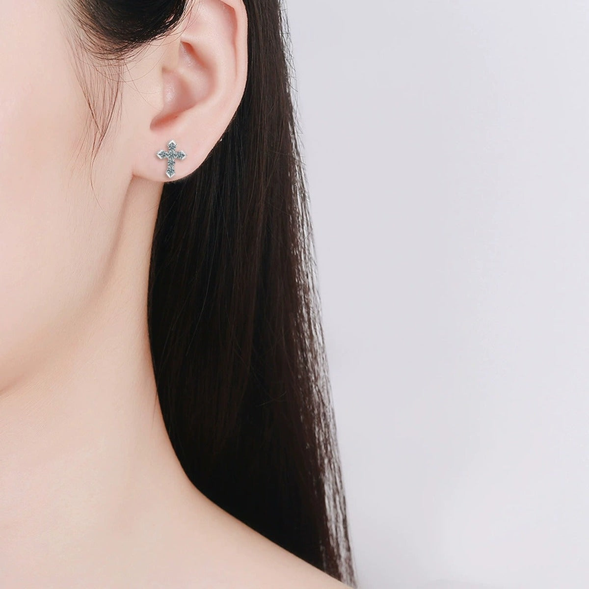 Cross Pave Round Moissanite Stud Earrings in White Gold-Plated S925 sterling silver worn on ear by model showing scale, placement, and stud earrings styling