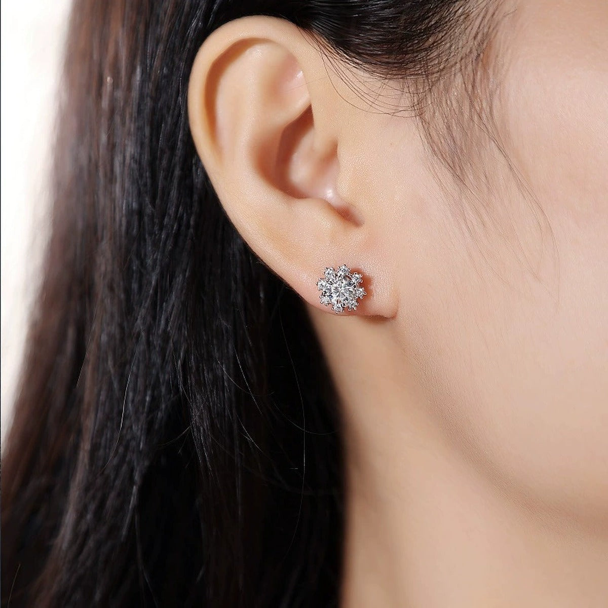 Snowflake Halo Round Moissanite Stud Earrings with CZ in White Gold-Plated S925 sterling silver worn on ear by model showing scale, placement, and stud earrings styling