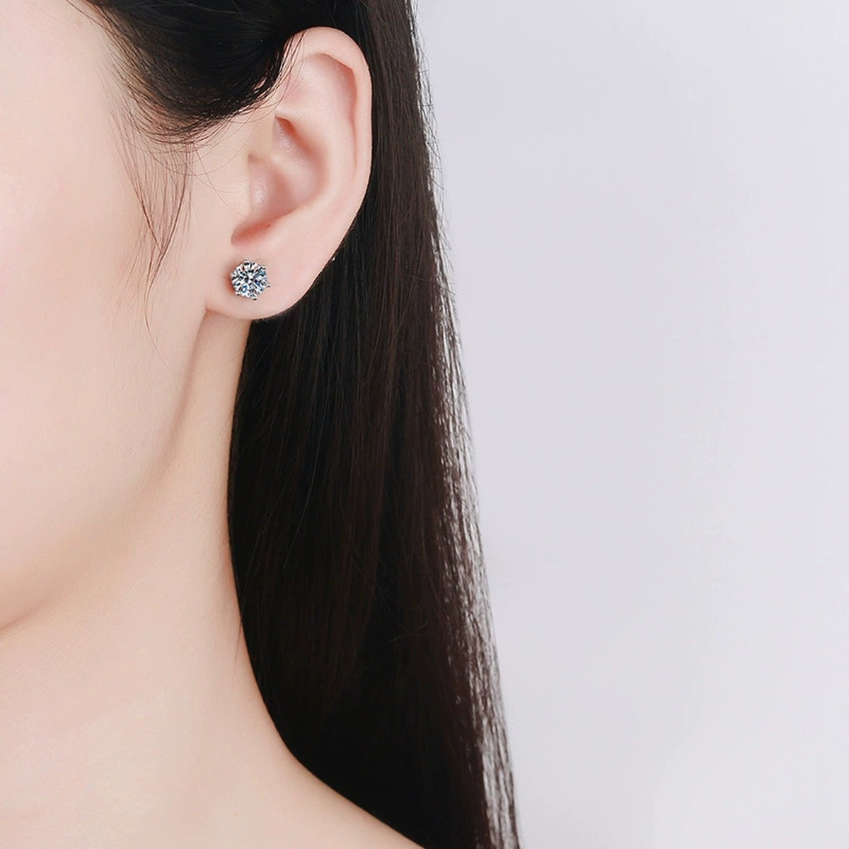 Six-Prong Round Moissanite Screw-Back Stud Earrings in Gold-Plated S925 sterling silver worn on ear by model showing scale, placement, and stud earrings styling