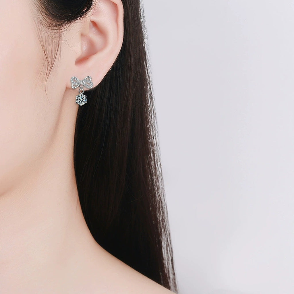 Bowknot Round Moissanite Stud Dangle Earrings with CZ in White Gold-Plated S925 sterling silver worn on ear by model showing scale, placement, and stud dangle earrings styling