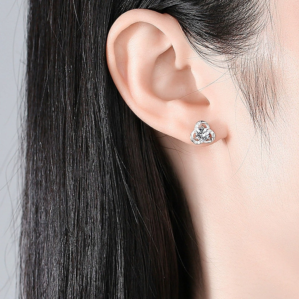 Three-Leaf Clover Round Moissanite Stud Earrings with CZ in White Gold-Plated S925 sterling silver worn on ear by model showing scale, placement, and stud earrings styling