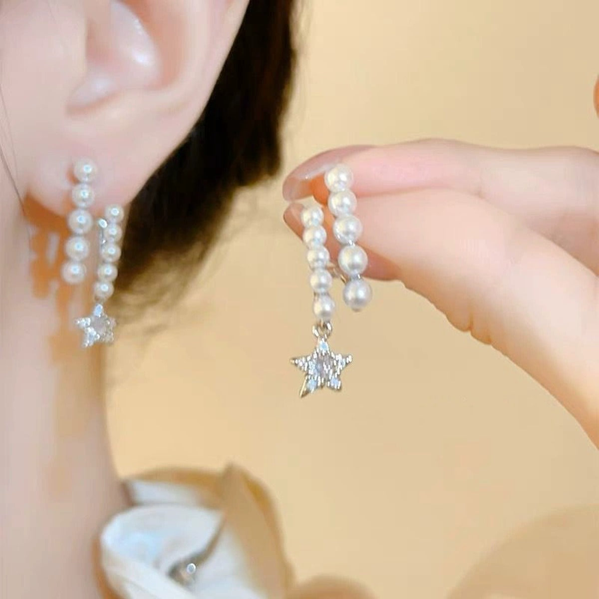 Pearl Star Moissanite Stud Dangle Earrings with CZ in White Gold-Plated S925 sterling silver worn on ear by model showing scale, placement, and stud dangle earrings styling
