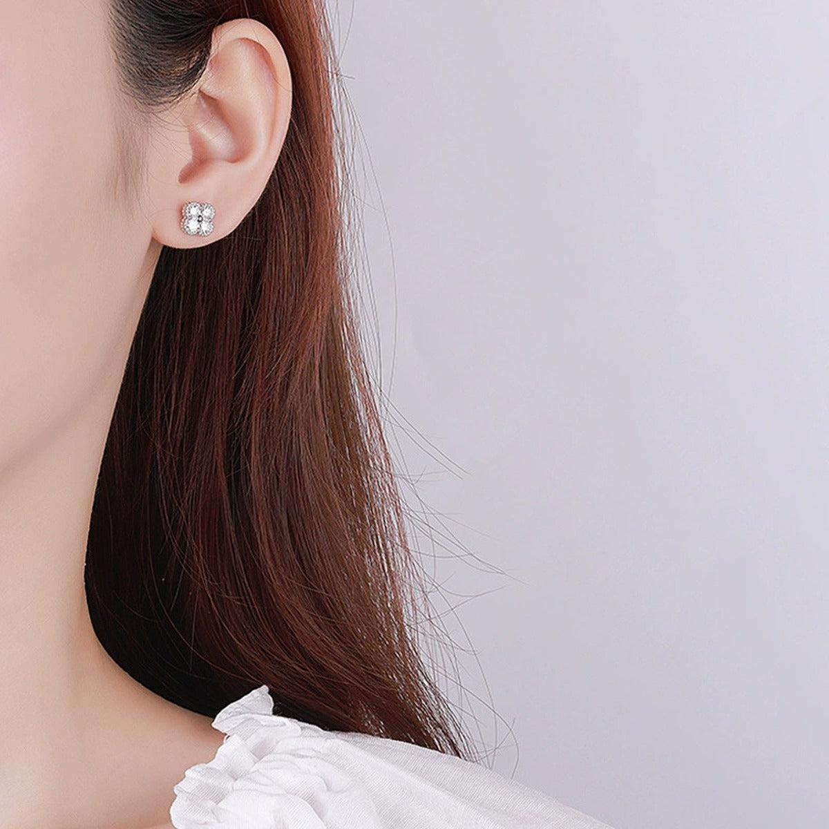 Four-Stone Clover Round Moissanite Stud Earrings in Gold-Plated S925 sterling silver worn on ear by model showing scale, placement, and stud earrings styling