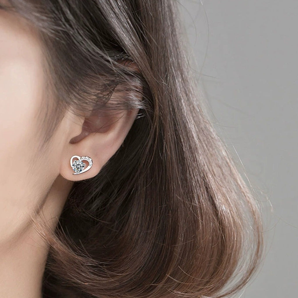 Heart Halo Round Moissanite Stud Earrings with CZ in Gold-Plated S925 sterling silver worn on ear by model showing scale, placement, and stud earrings styling