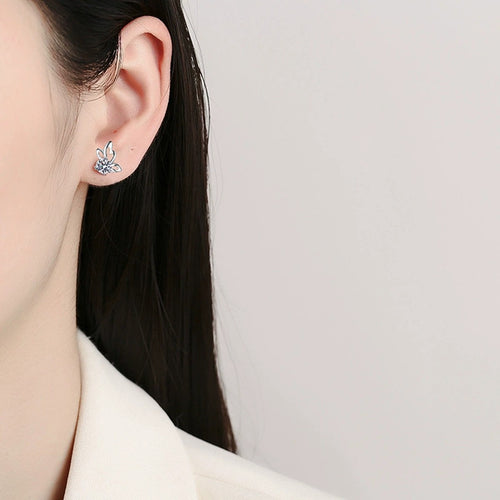 Butterfly Round Moissanite Stud Earrings in White Gold-Plated S925 sterling silver worn on ear by model showing scale, placement, and stud earrings styling