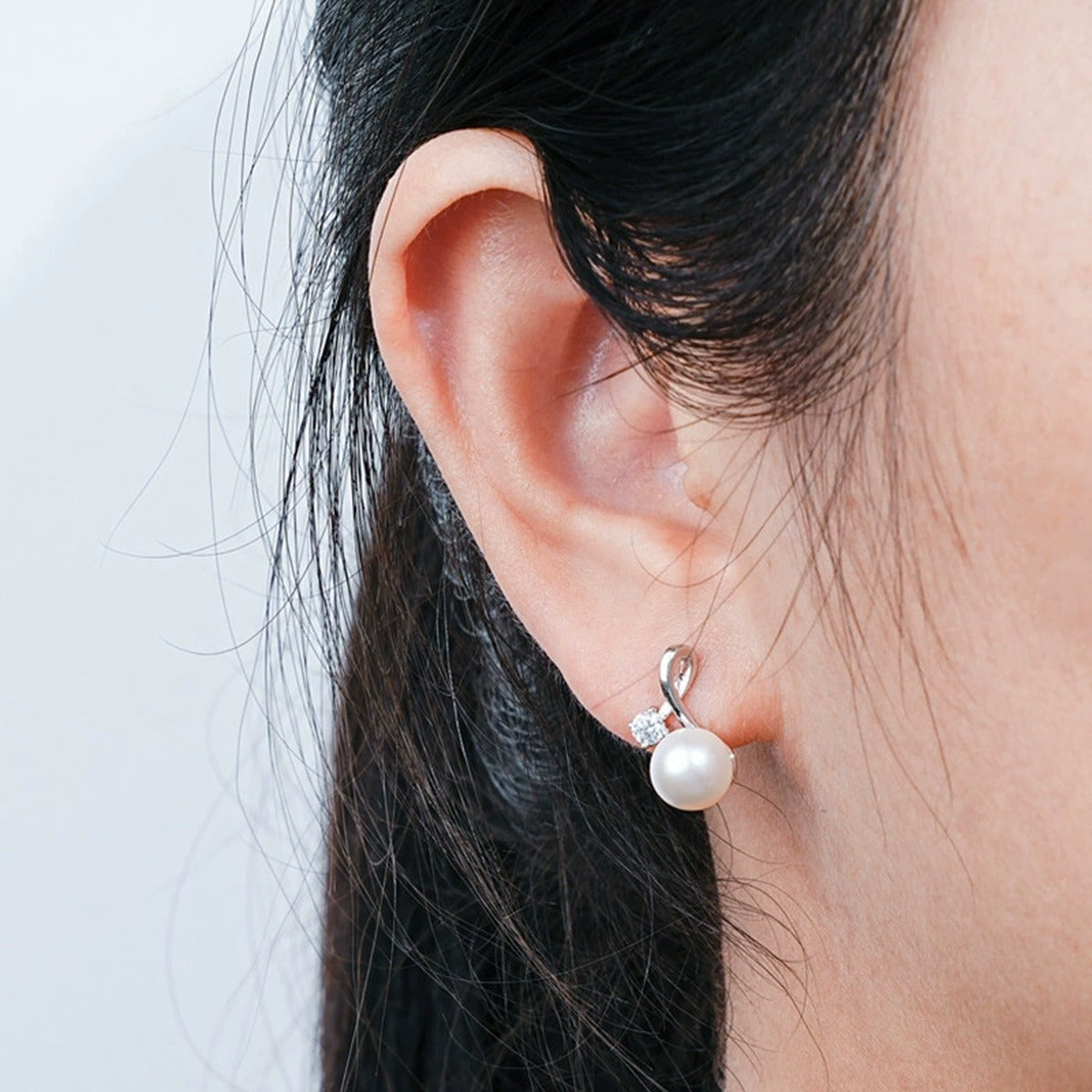 Pearl Round Moissanite Stud Drop Earrings in Gold-Plated S925 sterling silver worn on ear by model showing scale, placement, and stud drop earrings styling