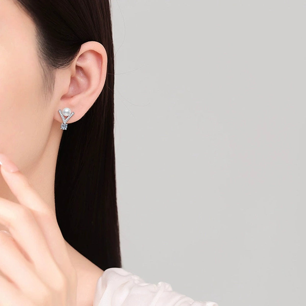 V-Frame Pearl Round Moissanite Stud Drop Earrings with CZ in Gold-Plated S925 sterling silver worn on ear by model showing scale, placement, and stud drop earrings styling