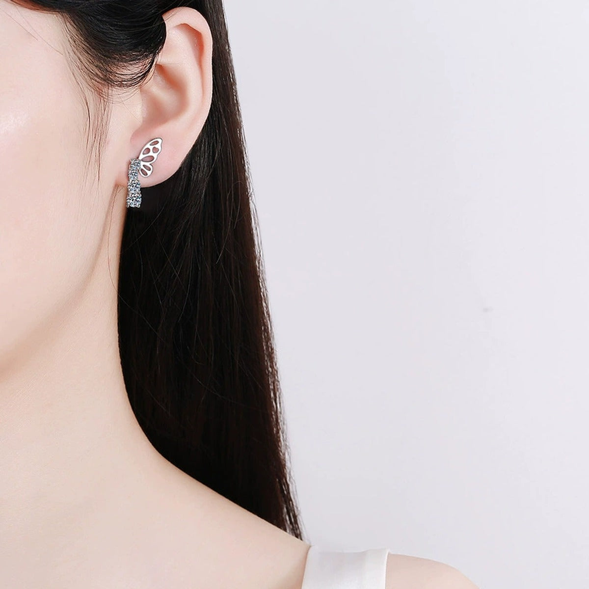 Butterfly Graduated Round Moissanite Stud Dangle Earrings in Gold-Plated S925 sterling silver worn on ear by model showing scale, placement, and stud dangle earrings styling