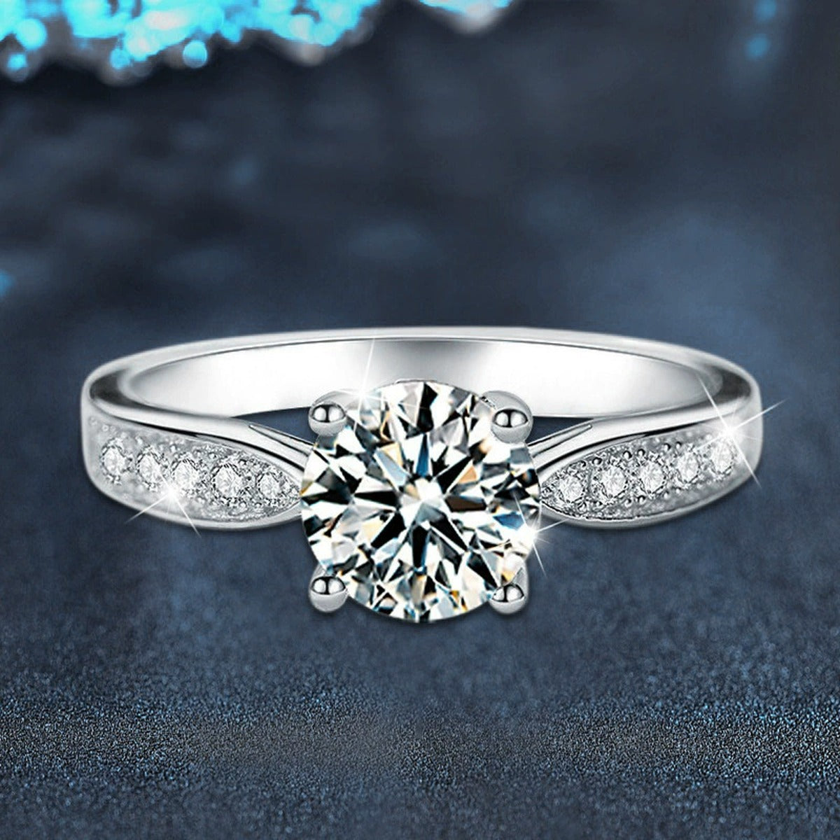 Four-Prong Round Moissanite Engagement Ring with CZ close-up detail view with moissanite sparkle