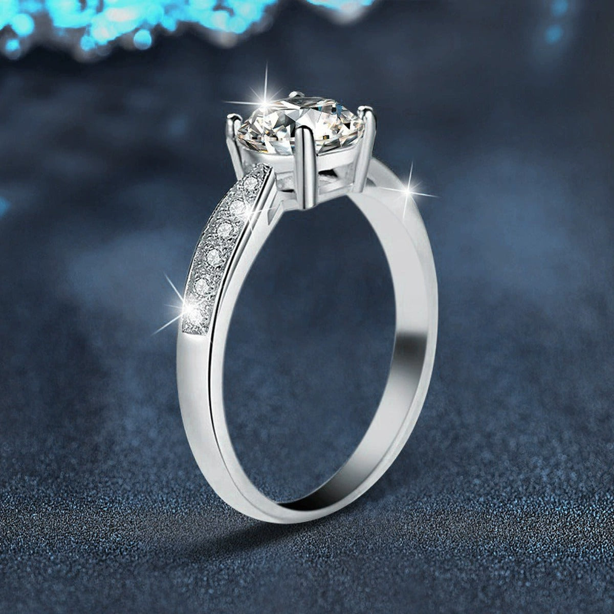 Four-Prong Round Moissanite Engagement Ring with CZ close-up detail view with moissanite sparkle