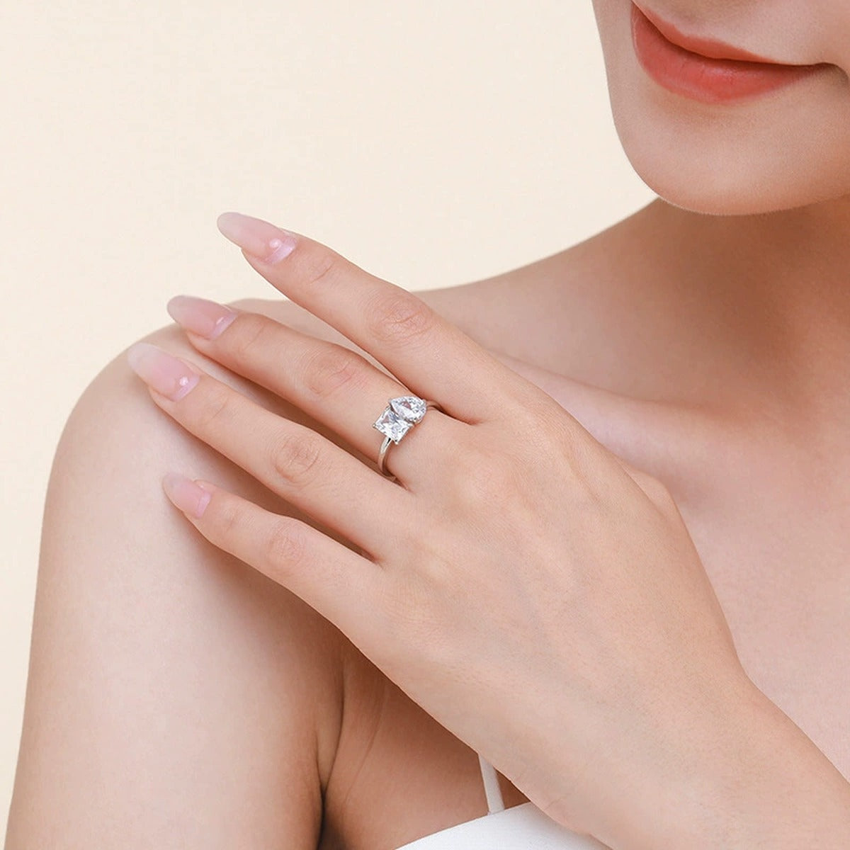Radiant and Pear Cut Moissanite Toi et Moi Engagement Ring worn on hand to show scale, band width, and ring profile