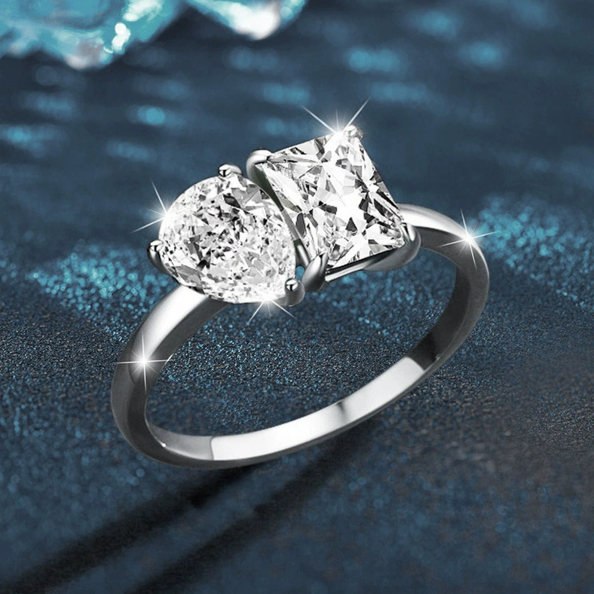 Radiant and Pear Cut Moissanite Toi et Moi Engagement Ring close-up detail view with moissanite sparkle