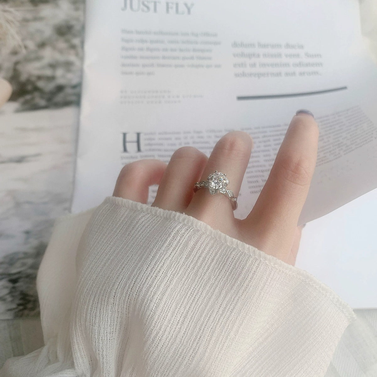 Floral Round Moissanite Adjustable Engagement Ring with CZ worn on hand to show scale, band width, and ring profile