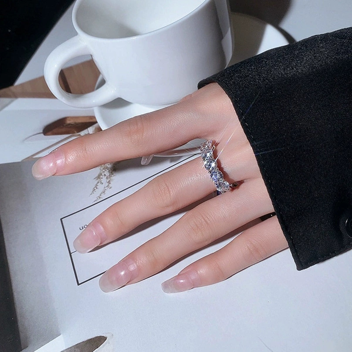 Graduated Round Moissanite Wedding Ring worn on hand to show scale, band width, and ring profile