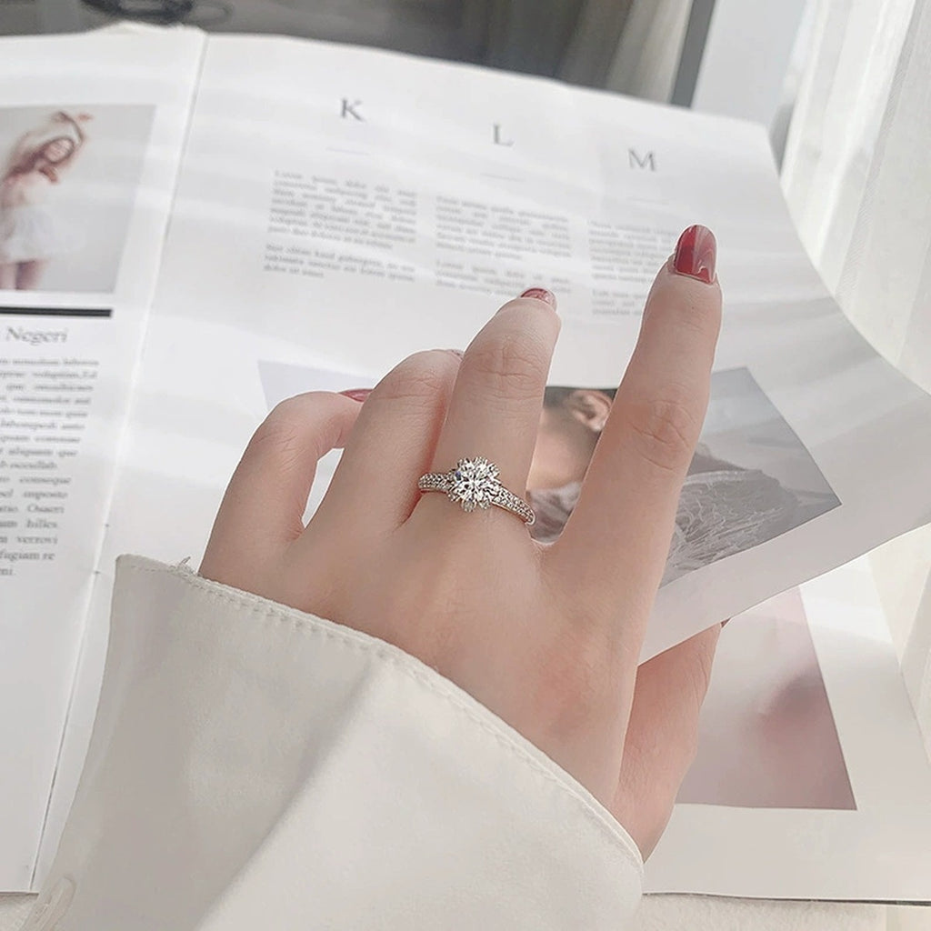Crown Six-Prong Round Moissanite Engagement Ring with CZ worn on hand to show scale, band width, and ring profile