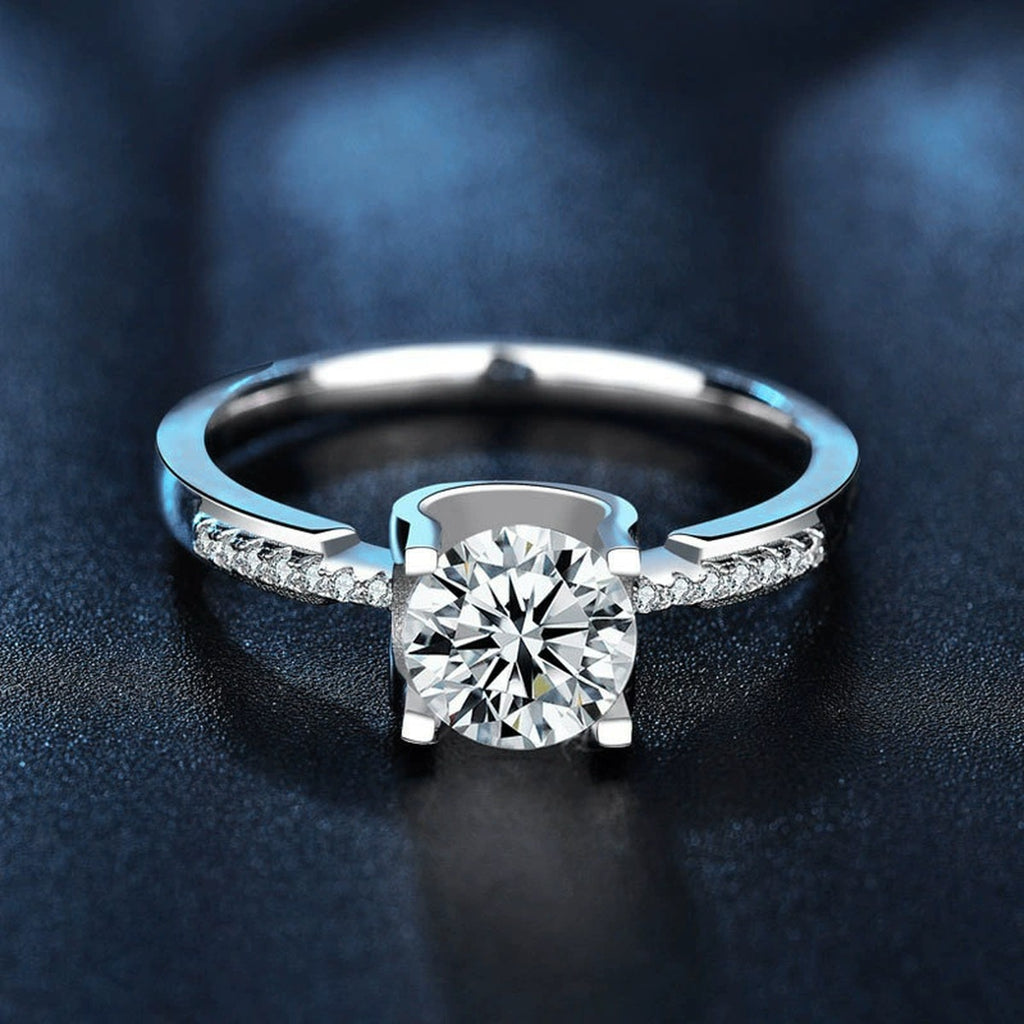 Four-Prong Round Moissanite Engagement Ring with CZ close-up detail view with moissanite sparkle