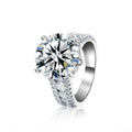 Oversized Four-Prong Round Moissanite Engagement Ring with CZ in white gold-plated S925 sterling silver on clean white background