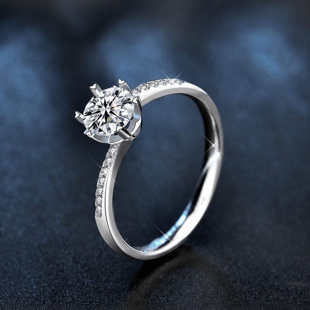 Six-Prong Round Moissanite Engagement Ring with CZ close-up detail view with moissanite sparkle