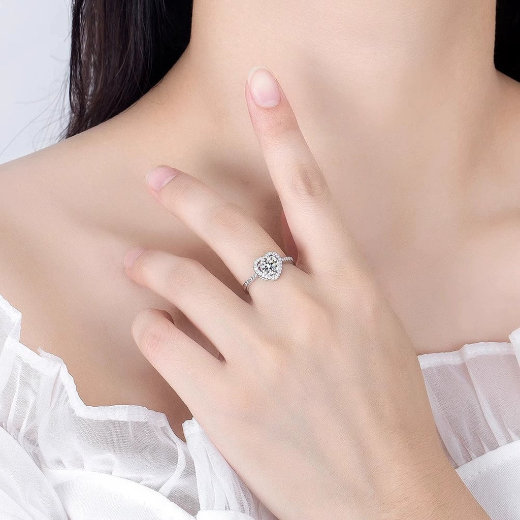Heart Motif Round Moissanite Adjustable Engagement Ring with CZ worn on hand to show scale, band width, and ring profile