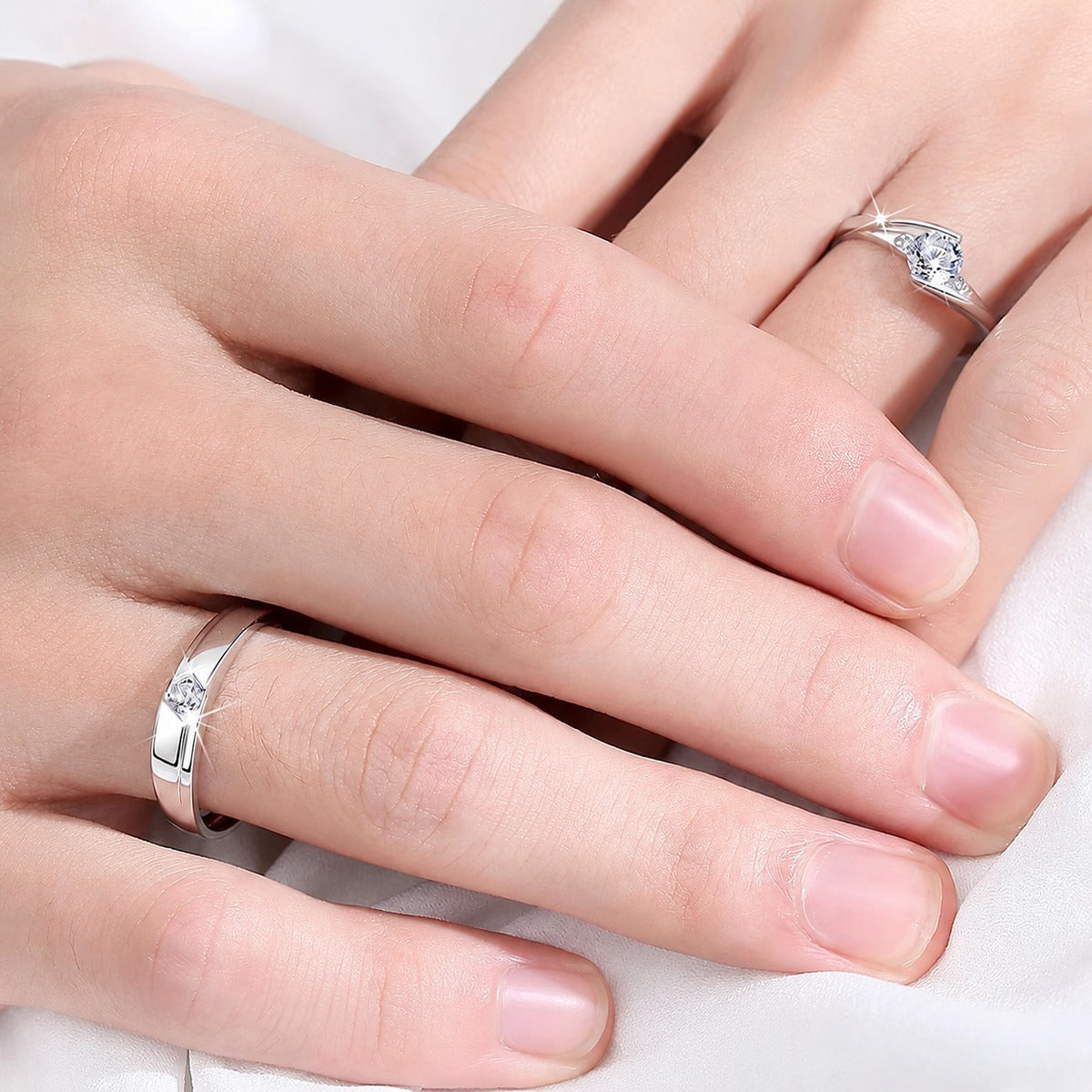 Classic Couples Round Moissanite Wedding Rings worn on hand to show scale, band width, and ring profile