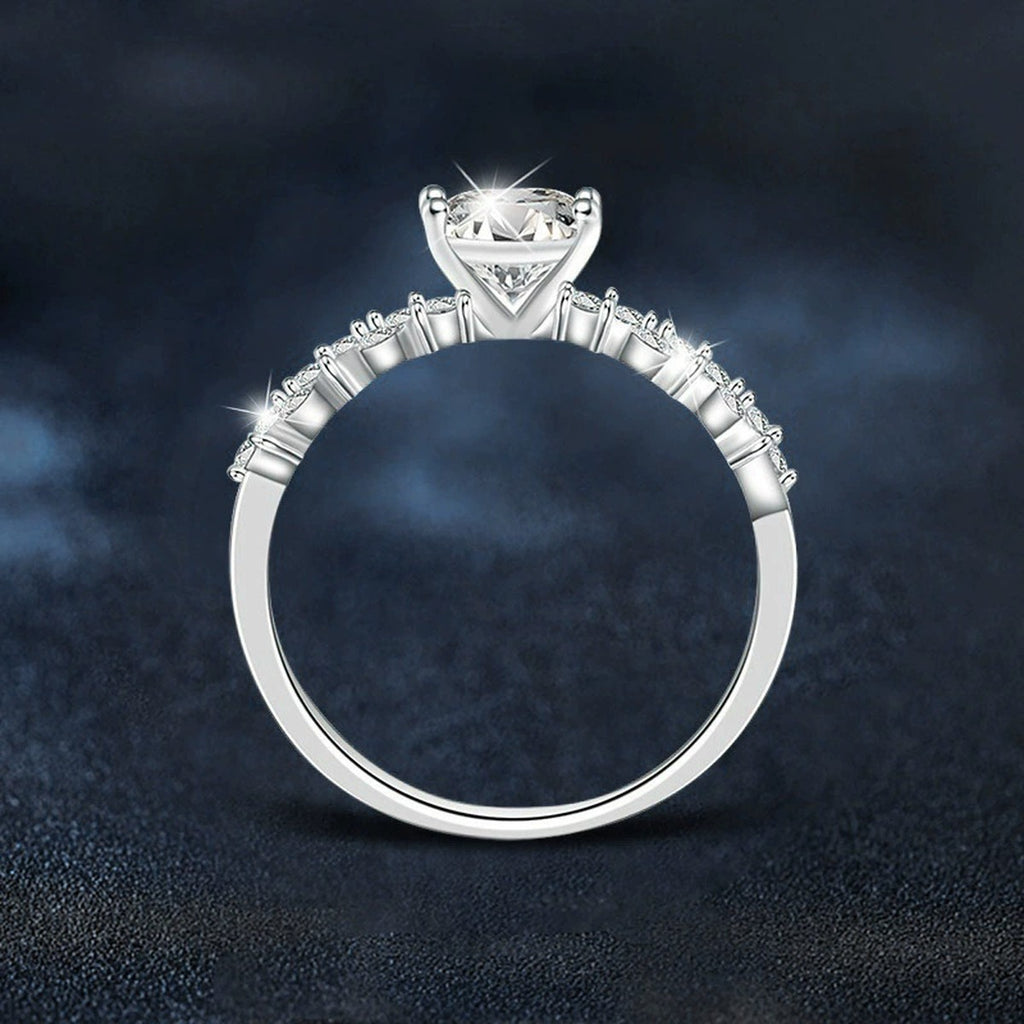Four-Prong Round Moissanite Engagement Ring with CZ close-up detail view with moissanite sparkle