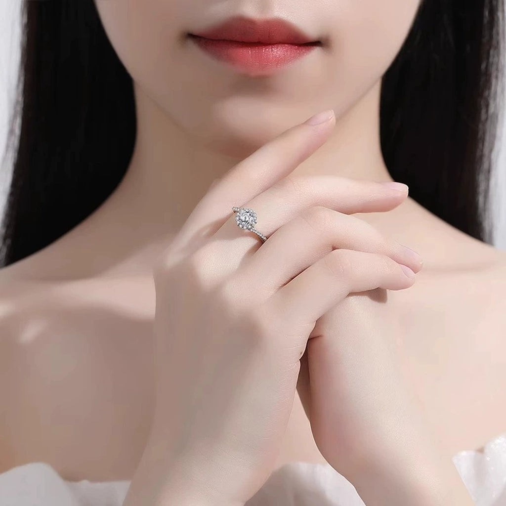 Floral Halo Round Moissanite Adjustable Engagement Ring with CZ worn on hand to show scale, band width, and ring profile