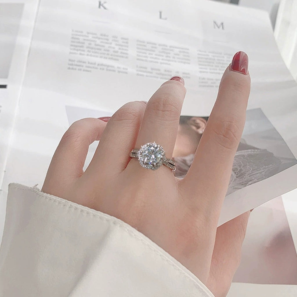 Floral Halo Round Moissanite Adjustable Engagement Ring with CZ worn on hand to show scale, band width, and ring profile