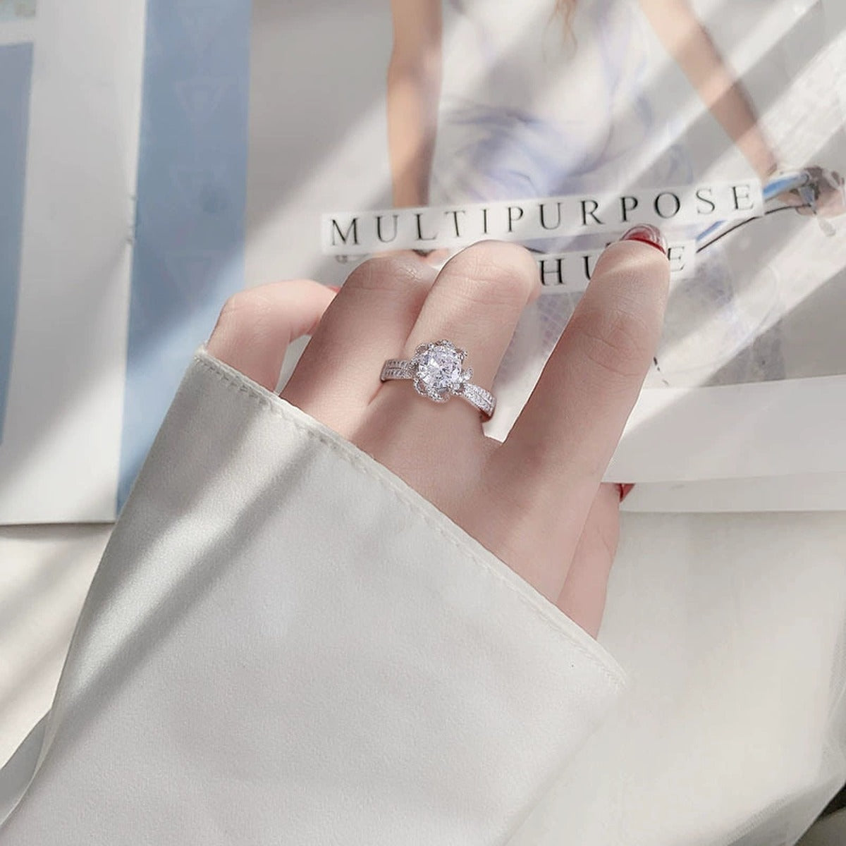 Rose Motif Round Moissanite Adjustable Engagement Ring with CZ worn on hand to show scale, band width, and ring profile