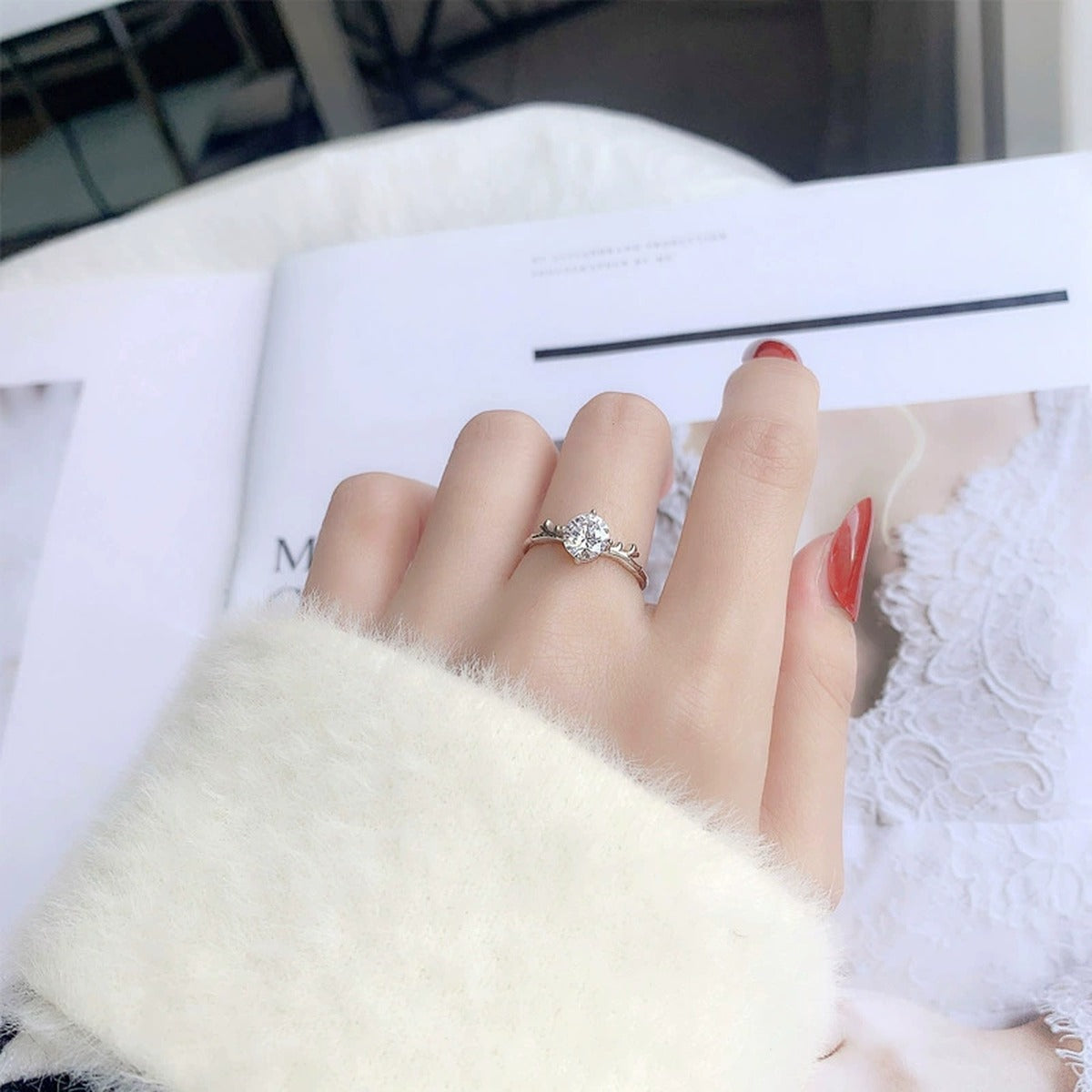 Antler Four-Prong Round Moissanite Adjustable Engagement Ring worn on hand to show scale, band width, and ring profile