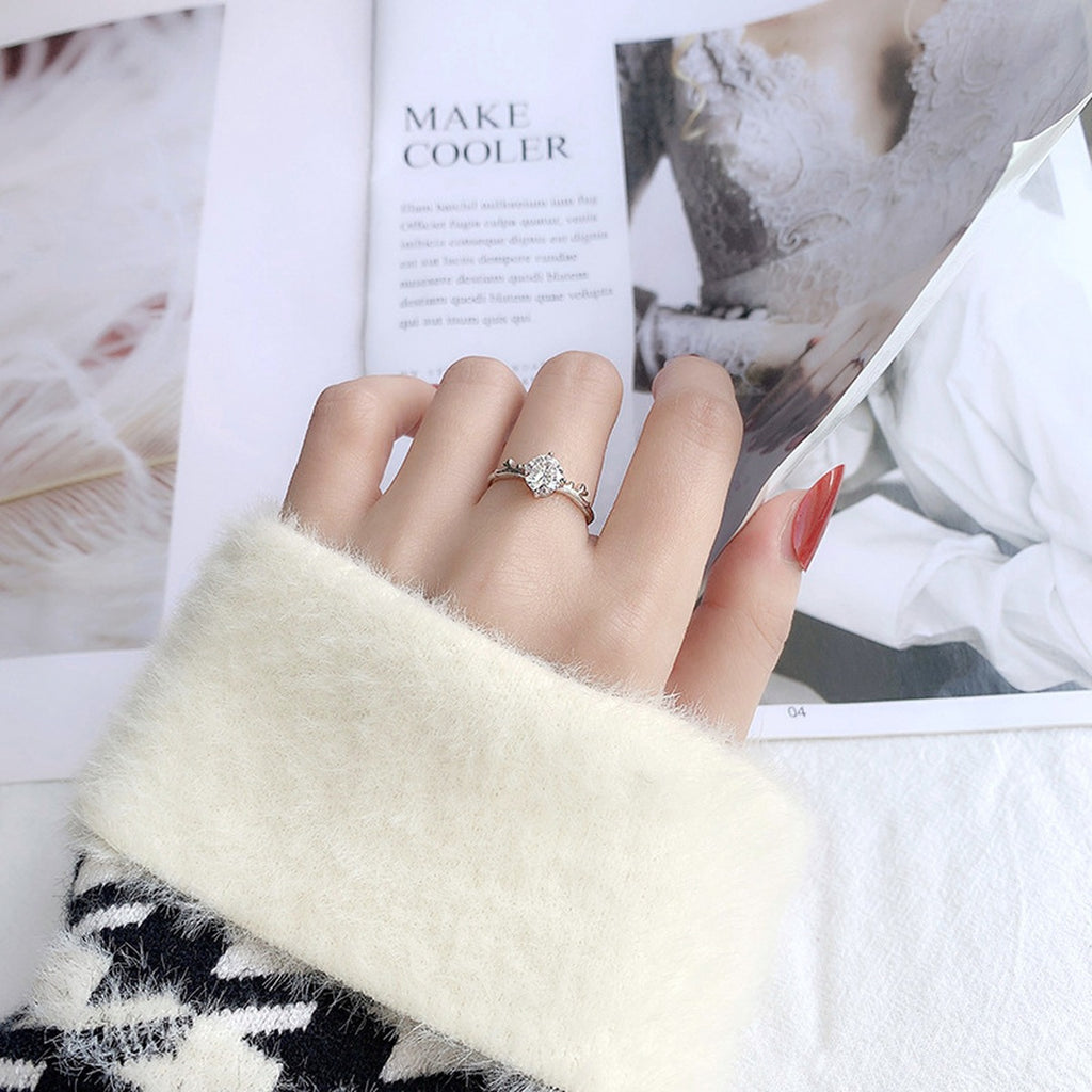 Antler Four-Prong Round Moissanite Adjustable Engagement Ring worn on hand to show scale, band width, and ring profile