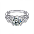 Leaf Motif Four-Prong Round Moissanite Engagement Ring with CZ in white gold-plated S925 sterling silver on clean white background