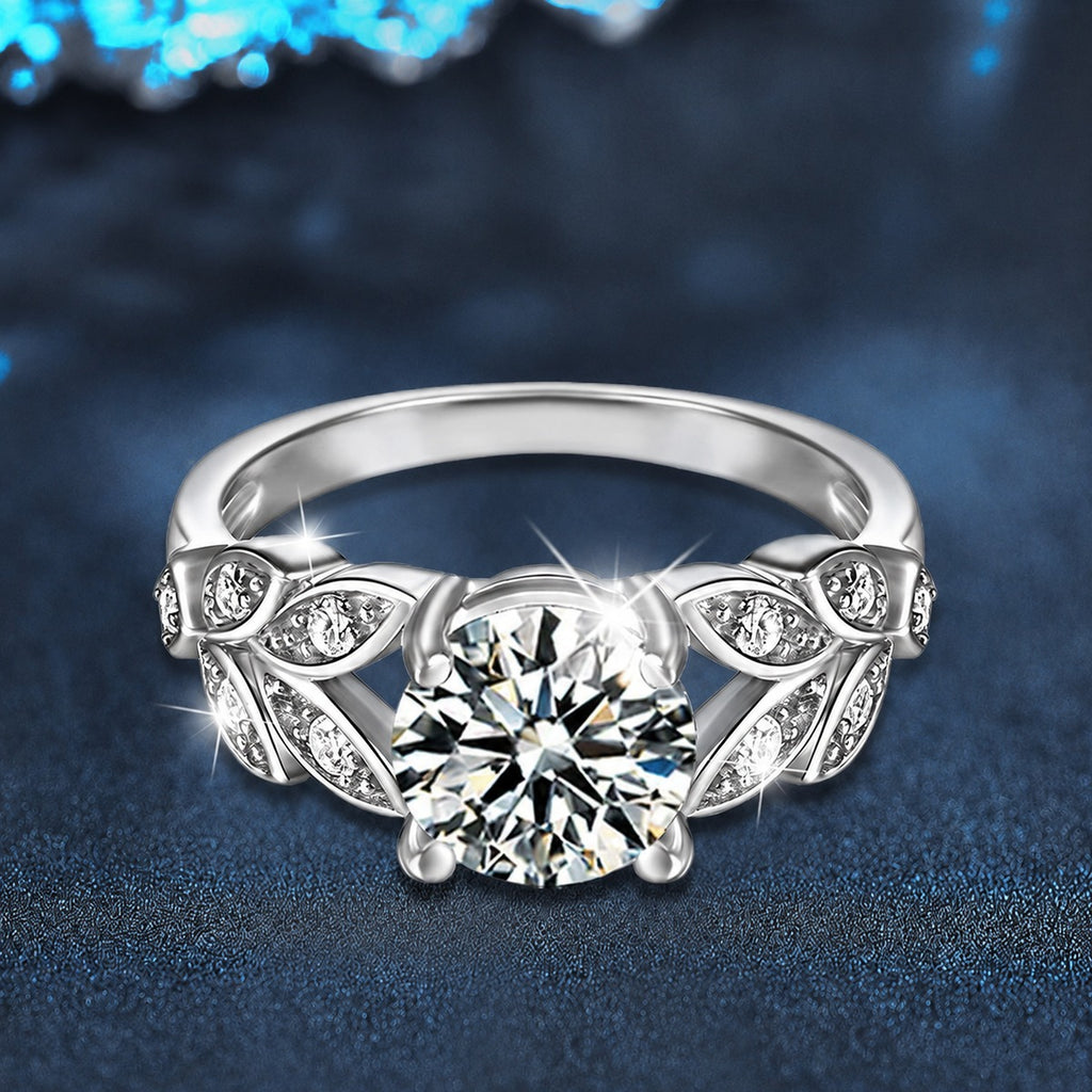 Leaf Motif Four-Prong Round Moissanite Engagement Ring with CZ close-up detail view with moissanite sparkle