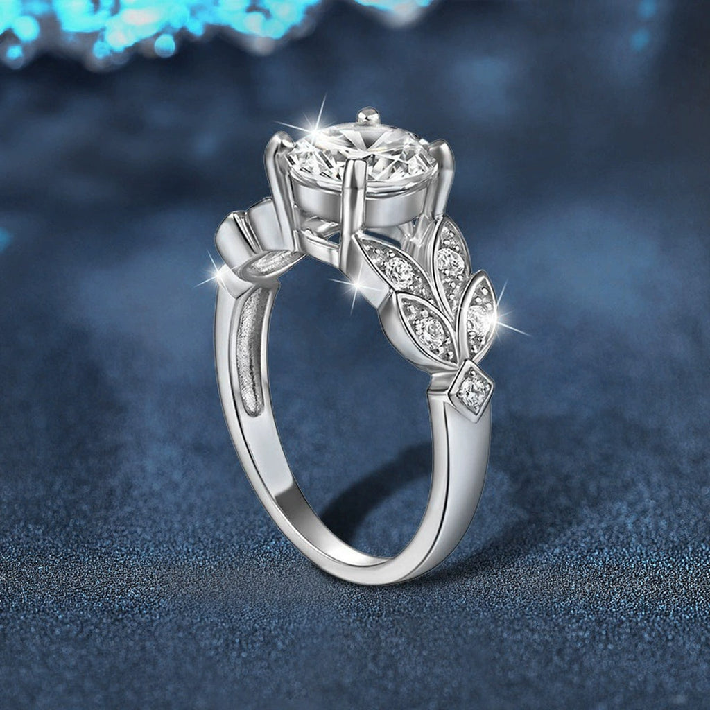 Leaf Motif Four-Prong Round Moissanite Engagement Ring with CZ close-up detail view with moissanite sparkle