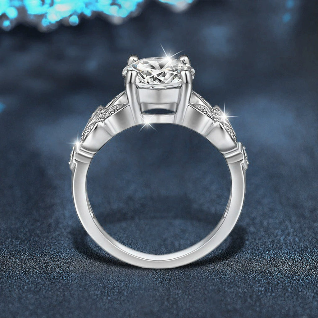 Leaf Motif Four-Prong Round Moissanite Engagement Ring with CZ close-up detail view with moissanite sparkle