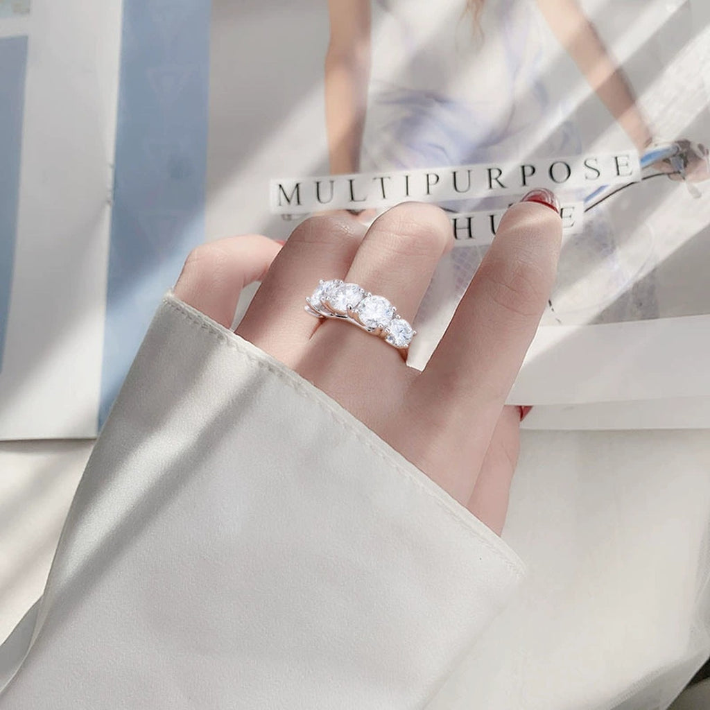 Five-Stone Graduated Round Moissanite Wedding Ring worn on hand to show scale, band width, and ring profile