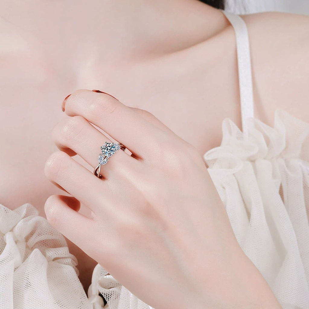 Floral Six-Prong Round Moissanite Engagement Ring with CZ worn on hand to show scale, band width, and ring profile