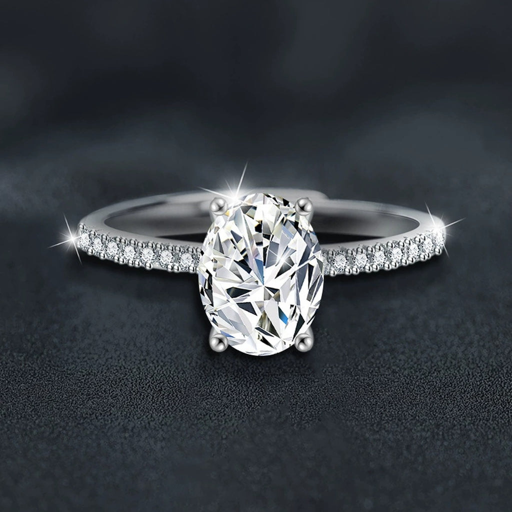 Four-Prong Oval Moissanite Engagement Ring with CZ close-up detail view with moissanite sparkle