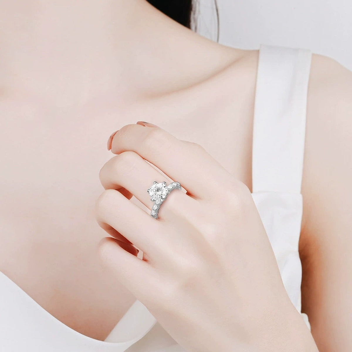 Six-Prong Round Moissanite Engagement Ring with CZ worn on hand to show scale, band width, and ring profile