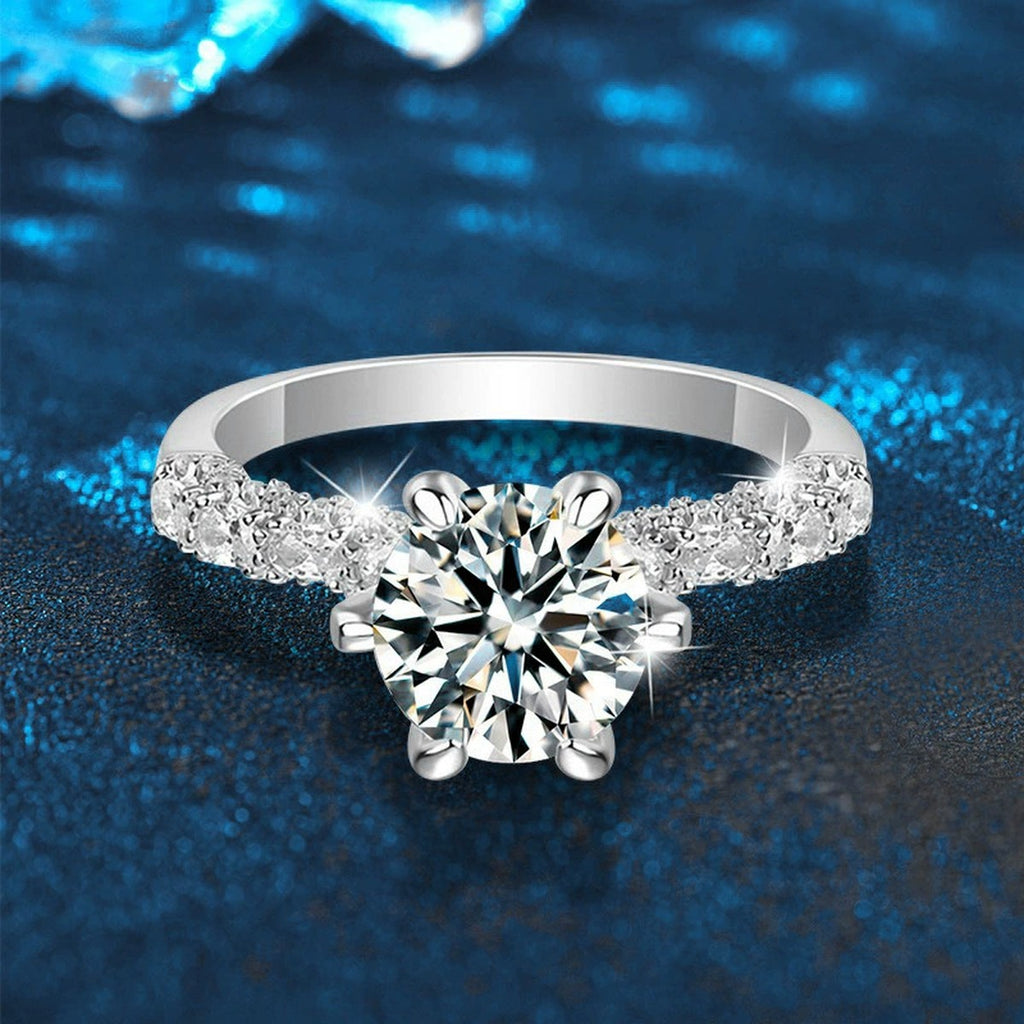 Six-Prong Round Moissanite Engagement Ring with CZ close-up detail view with moissanite sparkle