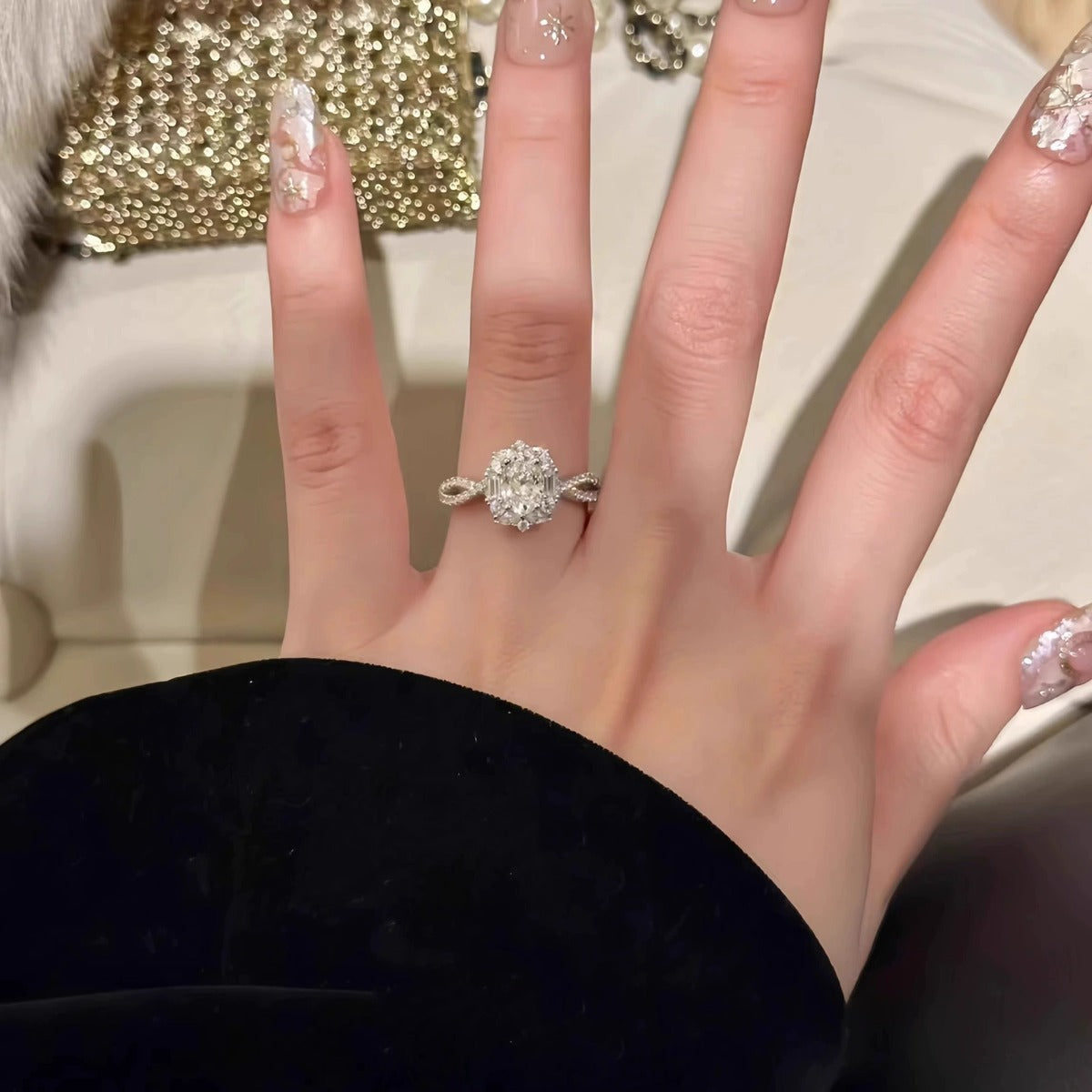 Oval Cut Moissanite Floral Engagement Ring with CZ worn on hand to show scale, band width, and ring profile