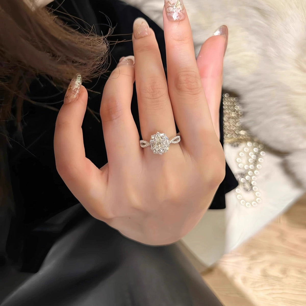 Oval Cut Moissanite Floral Engagement Ring with CZ worn on hand to show scale, band width, and ring profile