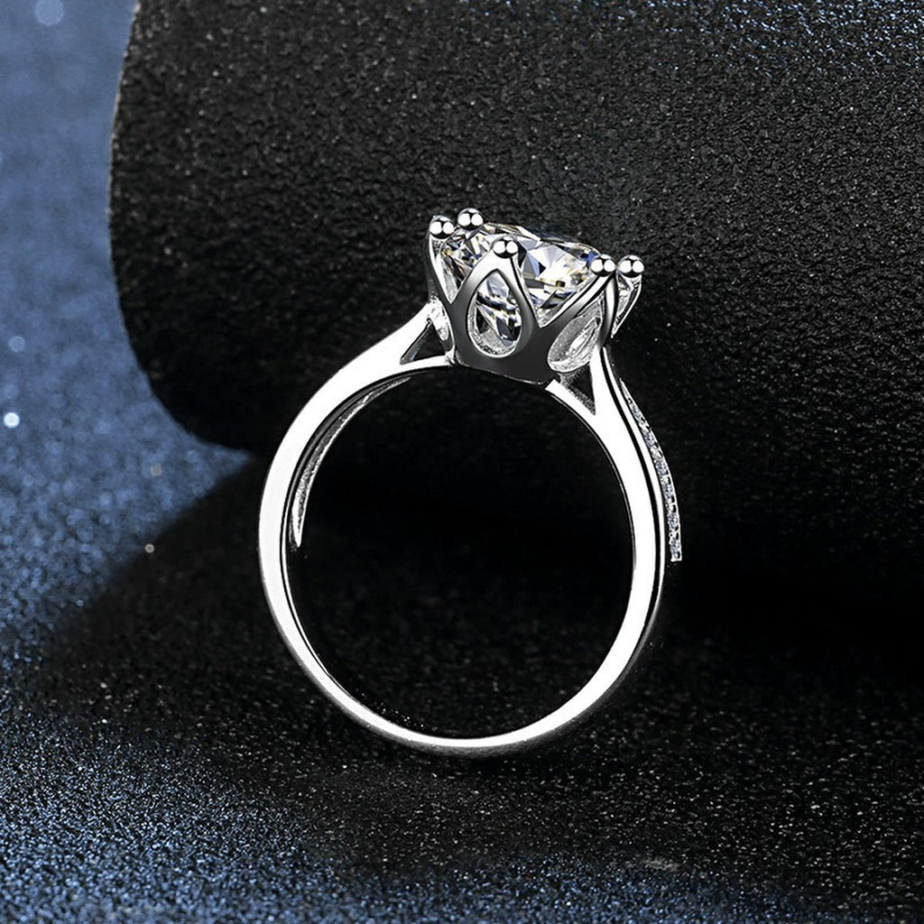 Six-Prong Round Moissanite Engagement Ring with CZ close-up detail view with moissanite sparkle