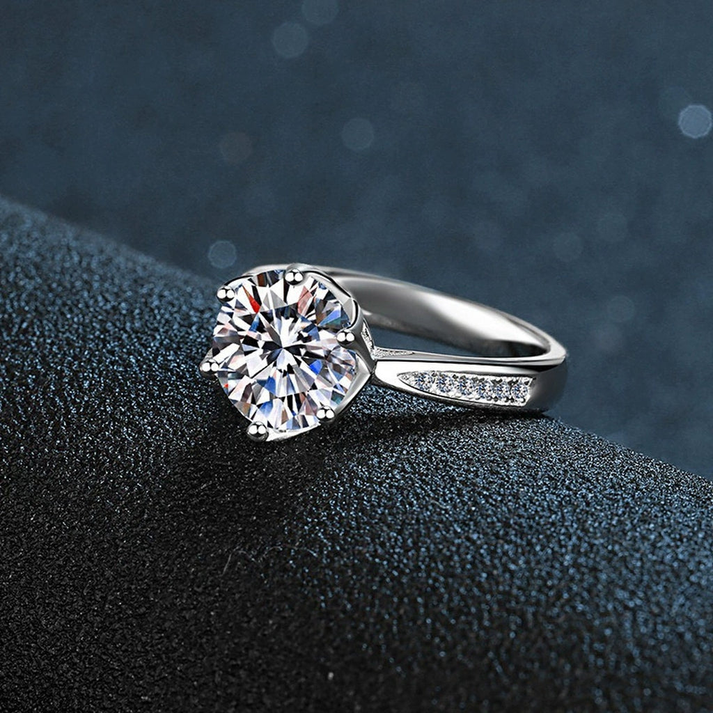 Six-Prong Round Moissanite Engagement Ring with CZ close-up detail view with moissanite sparkle